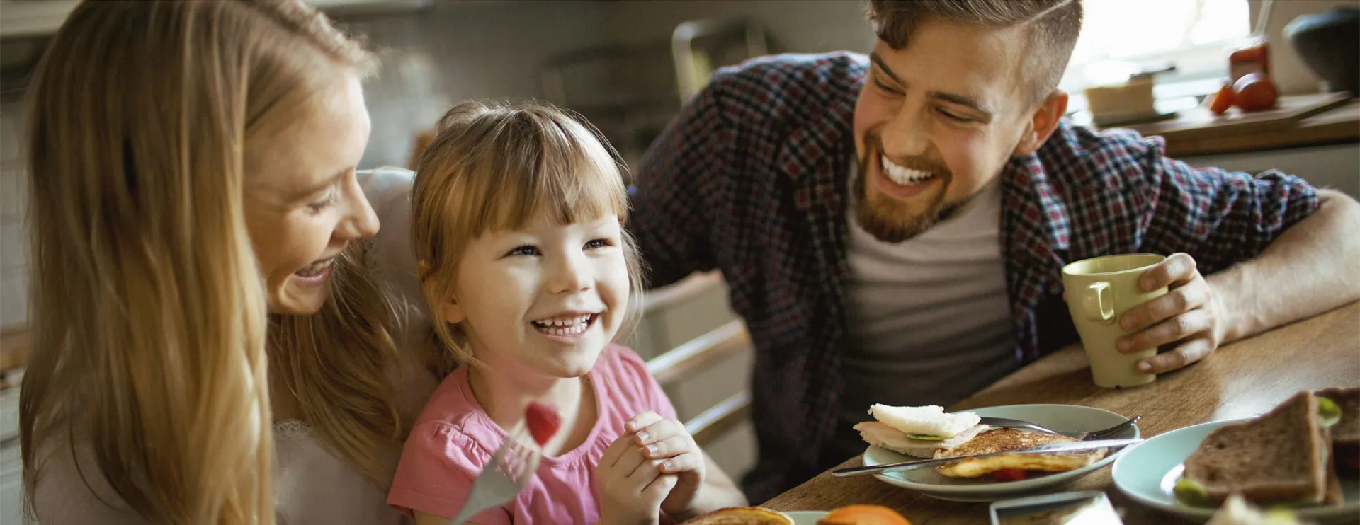 A family sharing breakfast together at a kitchen table